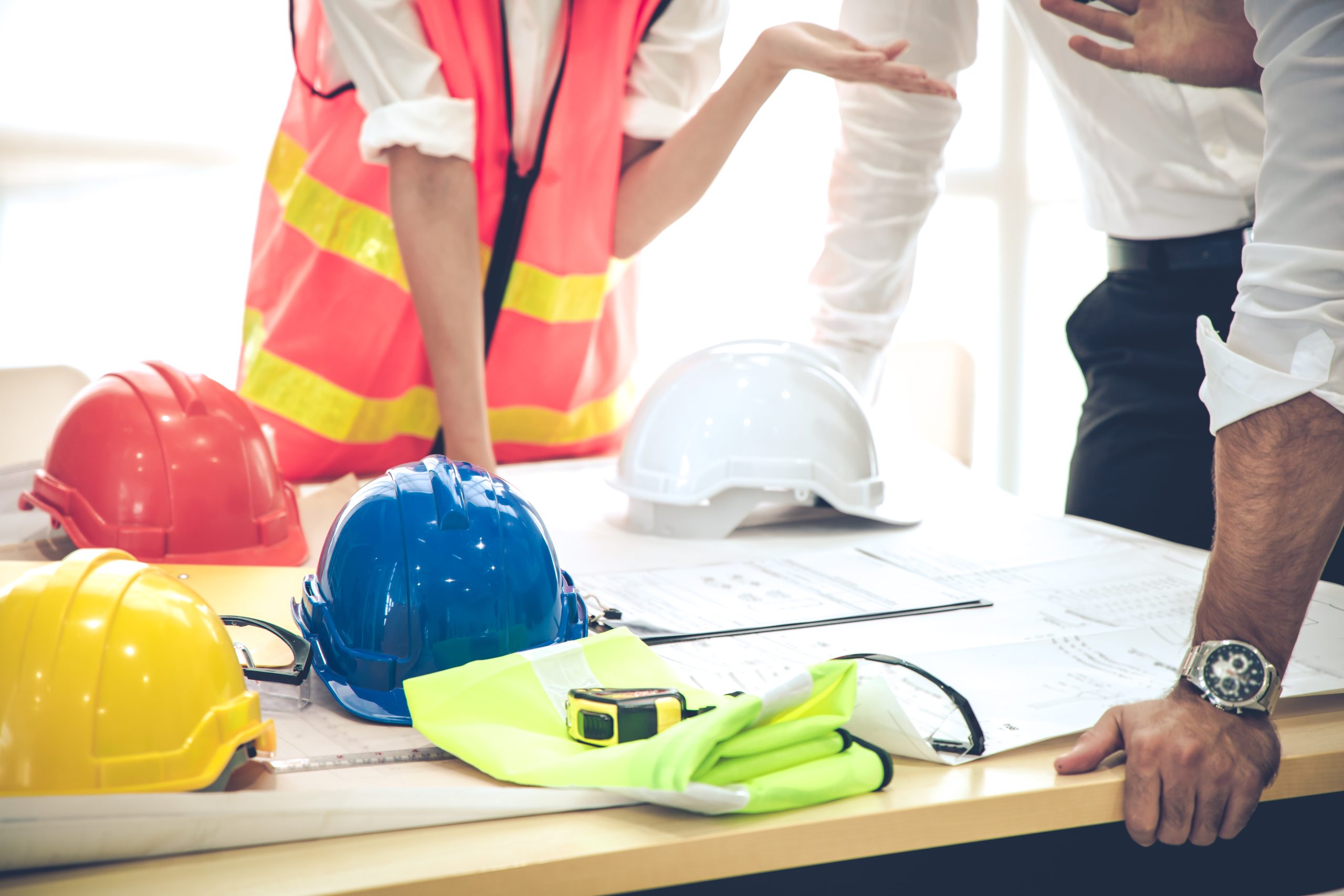 Three architects at the table and discussing design project.